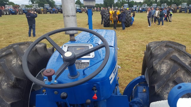 99 County tractors cluster together in one field