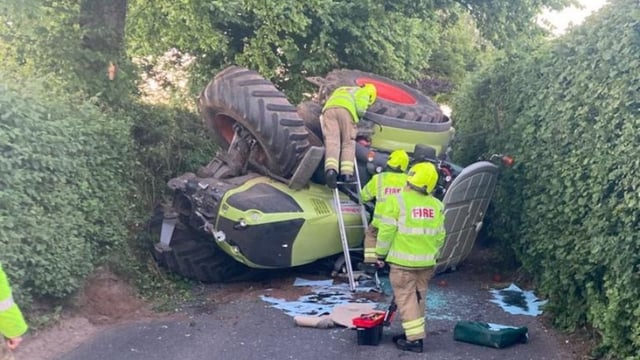 Tractor overturns on country lane in Gloucestershire